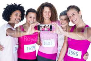 Smiling athletes taking self portrait with smartphone