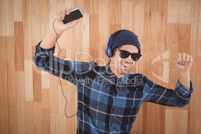 Happy hipster wearing headphones enjoying music