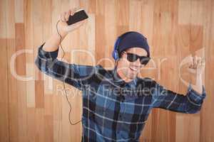 Happy hipster wearing headphones enjoying music