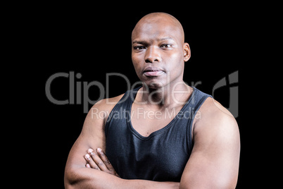 Portrait of bald bodybuilder with arms crossed