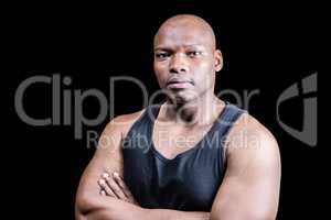Portrait of bald bodybuilder with arms crossed