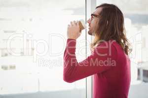 Side view of hipster drinking coffee