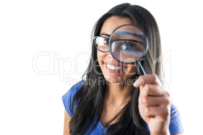 Happy woman using a magnifying glass