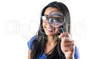 Happy woman using a magnifying glass