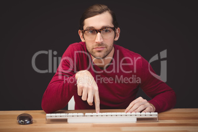 Portrait of man pointing at keyboard