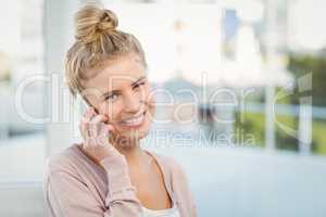 Portrait of smiling woman talking on smartphone