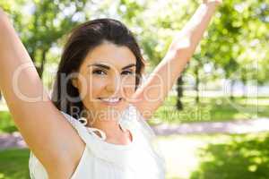 Portrait of happy woman with arms raised