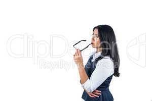 Woman holding her glasses against her lips
