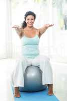 Pregnant woman exercising with ball