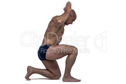 Side view of muscular man exercising