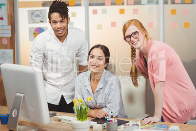 Smiling business people at desk