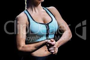 Midsection of fit woman stretching hands