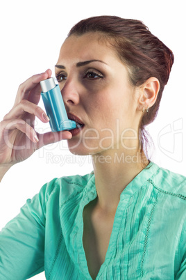 Woman using asthma inhaler