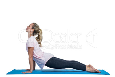 Side view of fit woman exercising on mat