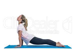 Side view of fit woman exercising on mat