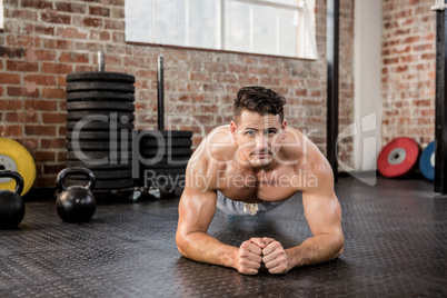 Portrait of a shirtless man doing push ups