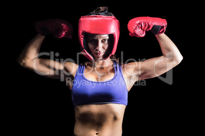 Portrait of confident female fighter flexing muscles