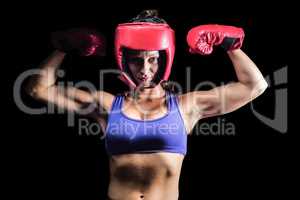 Portrait of confident female fighter flexing muscles