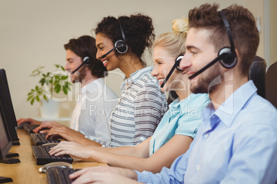 Smiling executives working in call center