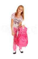 Schoolgirl lifting heavy backpack.