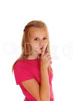 Pretty blond girl with finger over mouth.