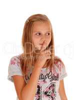 Young pretty girl with finger over mouth.