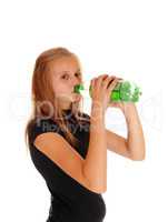 Girl drinking pop from bottle.