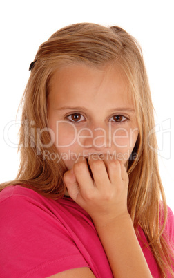 Young girl biting her fingernails.
