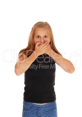 Young girl holding hands over mouth.