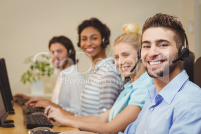 Portrait of smiling business people in call center