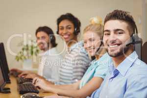 Portrait of smiling business people in call center