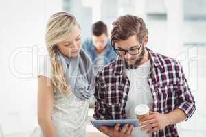 Man and woman working on digital tablet