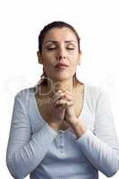 Beautiful woman praying with joining hands and eyes closed