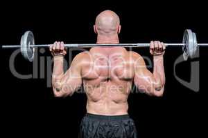 Rear view of bodybuilder lifting crossfit