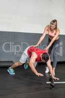 Fit man going plank exercises with trainer