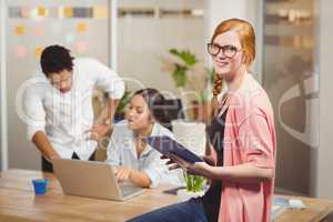 Portrait of businesswoman holding digital tablet in office