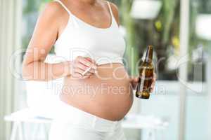 Midsection of woman with cigarette and alcohol