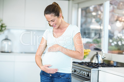 Happy woman standing in kitchen