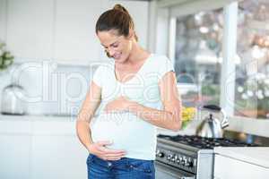 Happy woman standing in kitchen