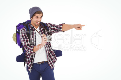 Happy man pointing while holding camera
