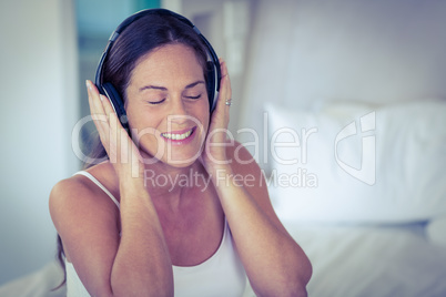 Happy woman listening to headphones