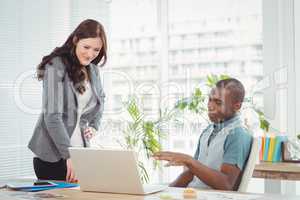 Smiling business professionals using laptop