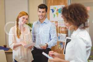 Business people standing in office with female colleague