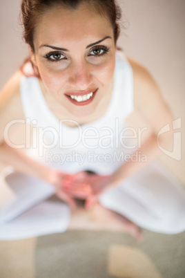 Overhead portrait of smiling woman in yoga pose