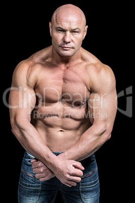 Portrait of bald man flexing muscles