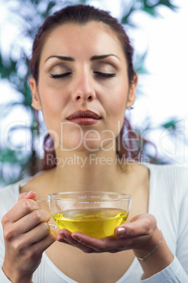 Woman smelling herbal tea