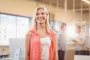 Businesswoman looking away while standing against male colleague