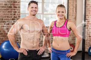 Standing muscular couple facing the camera