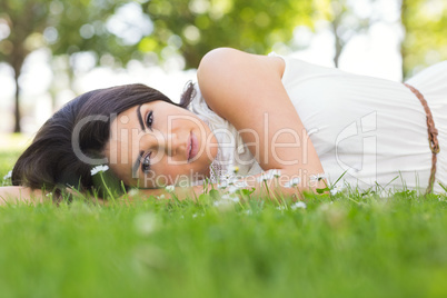 Portrait of beautiful woman relaxing on grassland