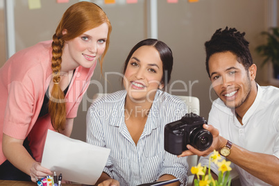 Business people with camera working in office